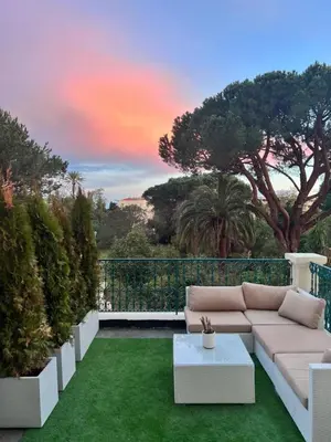 a living room with a couch on a green lawn at Prestige Cannes Alexandre III Terrace 2bdr by B'Your Home in Cannes