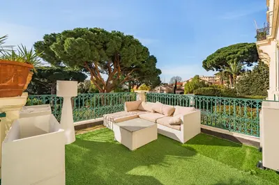 a patio with a couch and chairs on the grass at Prestige Cannes Alexandre III Terrace 2bdr by B'Your Home in Cannes