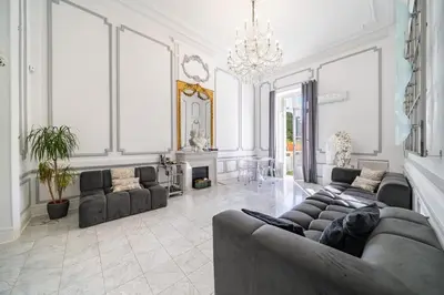 a large living room with couches and a chandelier at Prestige Cannes Alexandre III Terrace 2bdr by B'Your Home in Cannes