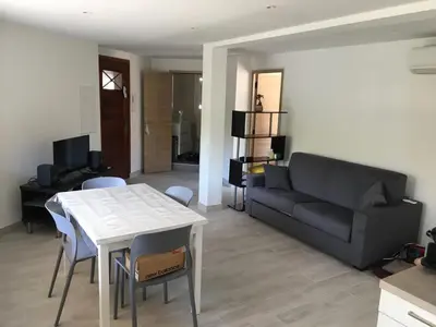 a living room with a couch and a table at Superbe Appartement Familial in Cannes