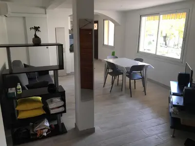 a room with a table and a dining room at Superbe Appartement Familial in Cannes