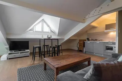 a living room with a couch and a table at Florella Jean Jaures Apartment in Cannes