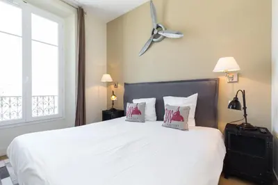a bedroom with a large white bed with two pillows at Florella Jean Jaures Apartment in Cannes
