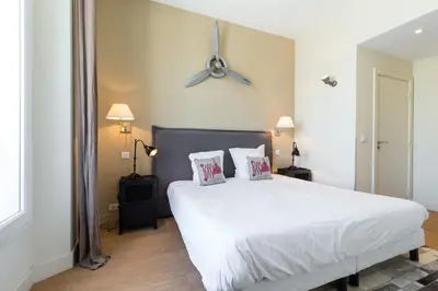 a bedroom with a large white bed with two pillows at Florella Jean Jaures Apartment in Cannes