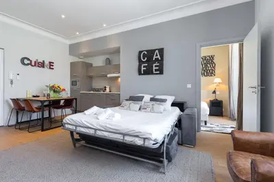 a bedroom with a bed and a dining room at Florella Jean Jaures Apartment in Cannes