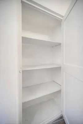 a white bedroom with a bed and a wooden floor at Cannes hyper centre quartier historique du suquet -palais-croisette in Cannes