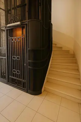 a set of stairs with a gate in a building at Studio chic à 200 m du Palais des Festivals, au cœur du shopping Cannois in Cannes