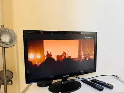 a computer monitor sitting on top of a desk at Studio chic à 200 m du Palais des Festivals, au cœur du shopping Cannois in Cannes