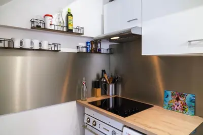 a kitchen with a sink and a counter top at Les voiles des Régates, à 5 minutes du centre à pied, 15 minutes de la mer in Cannes