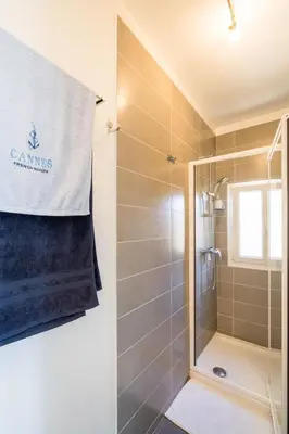 a bathroom with a shower with a glass door at Les voiles des Régates, à 5 minutes du centre à pied, 15 minutes de la mer in Cannes