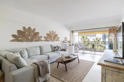 a living room with a couch and a table at PALM BEACH, sea view apartment, 100m from beaches in Cannes