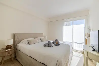 a bedroom with a bed with a teddy bear on it at PALM BEACH, sea view apartment, 100m from beaches in Cannes