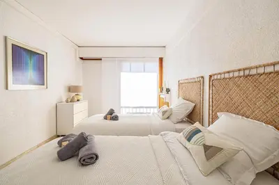 a bedroom with two beds and a window at PALM BEACH, sea view apartment, 100m from beaches in Cannes