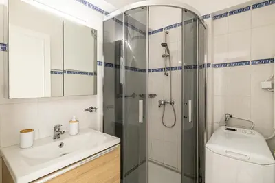 a bathroom with a shower and a sink and a toilet at PALM BEACH, sea view apartment, 100m from beaches in Cannes