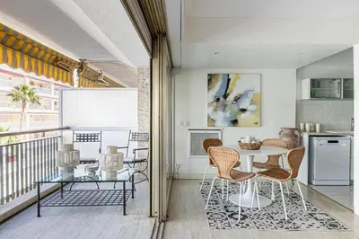 a dining room with a table and chairs at PALM BEACH, sea view apartment, 100m from beaches in Cannes