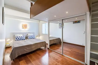 a bedroom with two beds and a mirror at Diane By Terrys Homes in Cannes