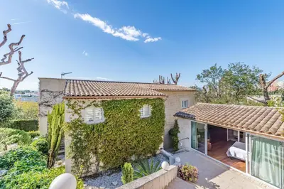 an exterior view of a house with ivy at Diane By Terrys Homes in Cannes