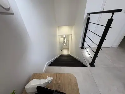 a stairway with a wooden table in a room at Le Baptiste in Cannes