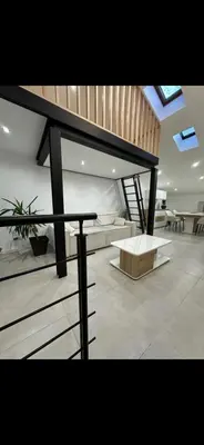 a living room with a couch and a table at Le Baptiste in Cannes