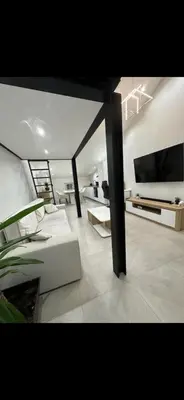 a living room with a couch and a tv at Le Baptiste in Cannes