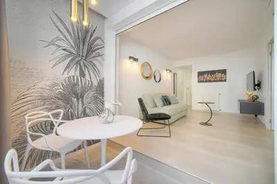 a living room with a table and chairs and a couch at Palace - Ultra center - 2 min sea - VCA in Cannes