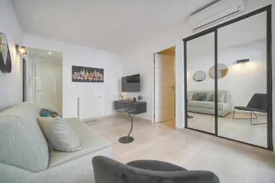 a living room with a couch and a table at Palace - Ultra center - 2 min sea - VCA in Cannes