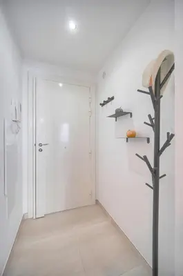 a hallway with a door and a tree in it at Palace - Ultra center - 2 min sea - VCA in Cannes
