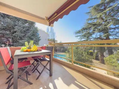 a table and chairs on a balcony with a view at Le Cozy by Winsome Destination in Cannes