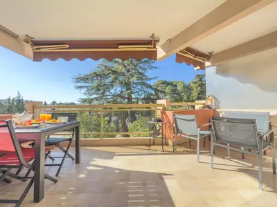 a patio with a table and chairs and a balcony at Le Cozy by Winsome Destination in Cannes