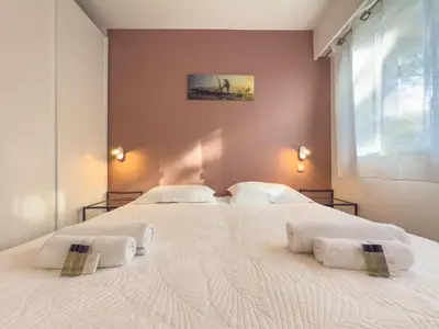 two beds in a bedroom with two white towels on them at Le Cozy by Winsome Destination in Cannes