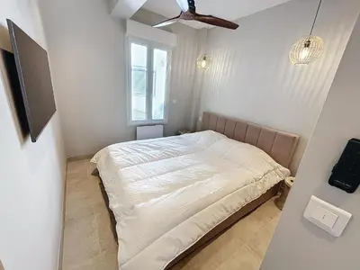 a room with a wooden cabinet with plants on it at Lovely 1 bedroom rue Pasteur near the Croisette 246 in Cannes