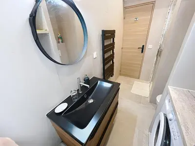a dining room with a table and chairs and windows at Lovely 1 bedroom rue Pasteur near the Croisette 246 in Cannes
