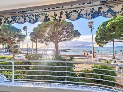 a view of the beach from a balcony at Le Romance - Palm Beach - Sea View - Wi-Fi - Air Conditioning in Cannes