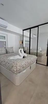 a bedroom with a large bed with a large mirror at Le Romance - Palm Beach - Sea View - Wi-Fi - Air Conditioning in Cannes