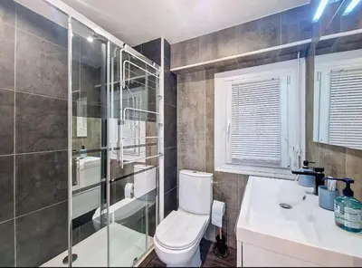 a bathroom with a toilet and a shower and a sink at Le Romance - Palm Beach - Sea View - Wi-Fi - Air Conditioning in Cannes
