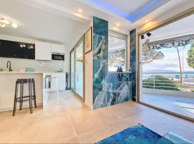 a large kitchen with a view of the ocean at Le Romance - Palm Beach - Sea View - Wi-Fi - Air Conditioning in Cannes