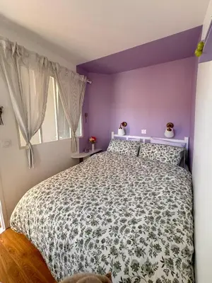 a bedroom with a large bed with purple walls at Vue mer imprenable, piscine à débordement - Cannes in Cannes
