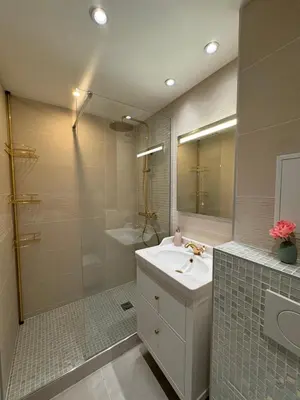 a bathroom with a sink and a shower and a mirror at Vue mer imprenable, piscine à débordement - Cannes in Cannes