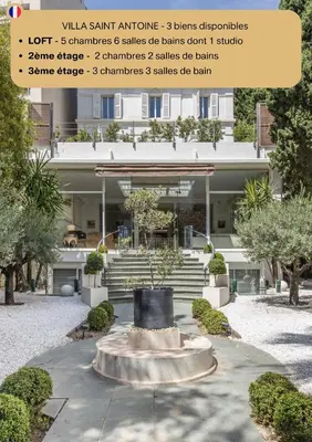 a sign in front of a building with a fountain at Heart of Cannes Luxury Stay - Steps from Beach & Palais in Cannes