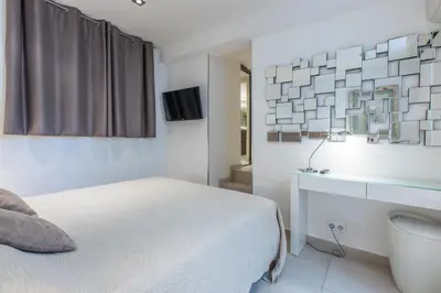 a bathroom with a tub and a sink and a mirror at Heart of Cannes Luxury Stay - Steps from Beach & Palais in Cannes