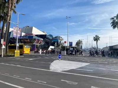 a city street with people walking and a street sign at Palais des festivals Studio meublé in Cannes