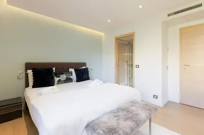 a bedroom with a large white bed and a bench at Immogroom Luxury 1 bedAppartment AC Terrace in Cannes