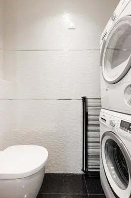 a bathroom with a washing machine next to a toilet at Immogroom Luxury 1 bedAppartment AC Terrace in Cannes