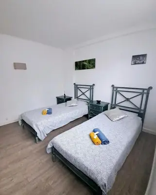 three beds sitting in a room with wooden floors at 4 - Person Apartment with Sea View terrace in Cannes