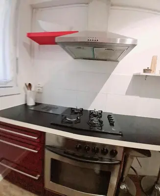 a kitchen with a stove top oven in a kitchen at 4 - Person Apartment with Sea View terrace in Cannes