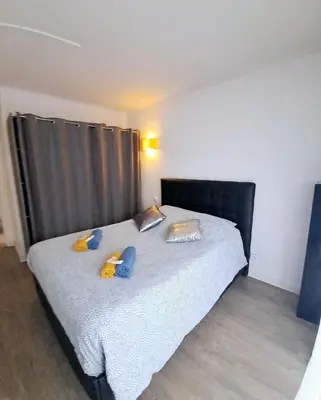 a bedroom with a bed with a black headboard at 4 - Person Apartment with Sea View terrace in Cannes