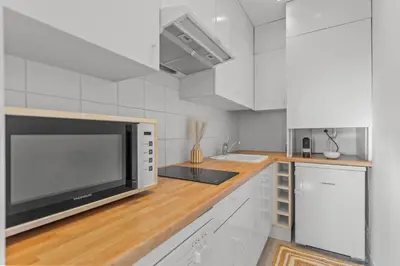 a kitchen with a microwave on a wooden counter at Appartement à Cannes in Cannes