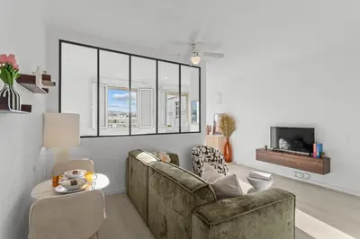 a living room with a couch and a tv at Appartement à Cannes in Cannes