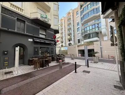 an empty street with tables and chairs and buildings at Verginia in Cannes