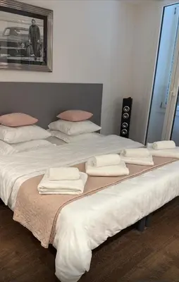 two beds with white sheets and towels on them at Verginia in Cannes